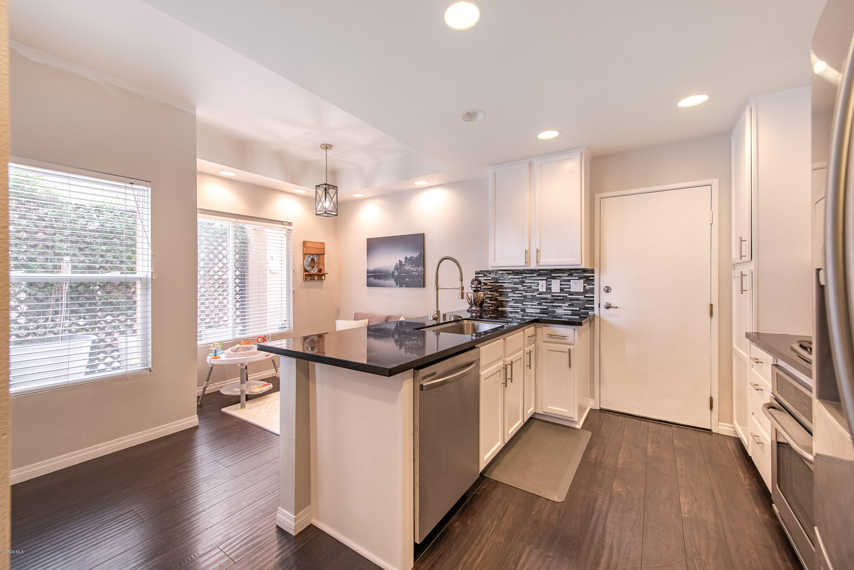 308 Hedge Row Lane, Unit B Simi Valley, CA 93065 - Photo 12 of 27 a kitchen with stainless steel appliances granite countertop a stove and a refrigerator
