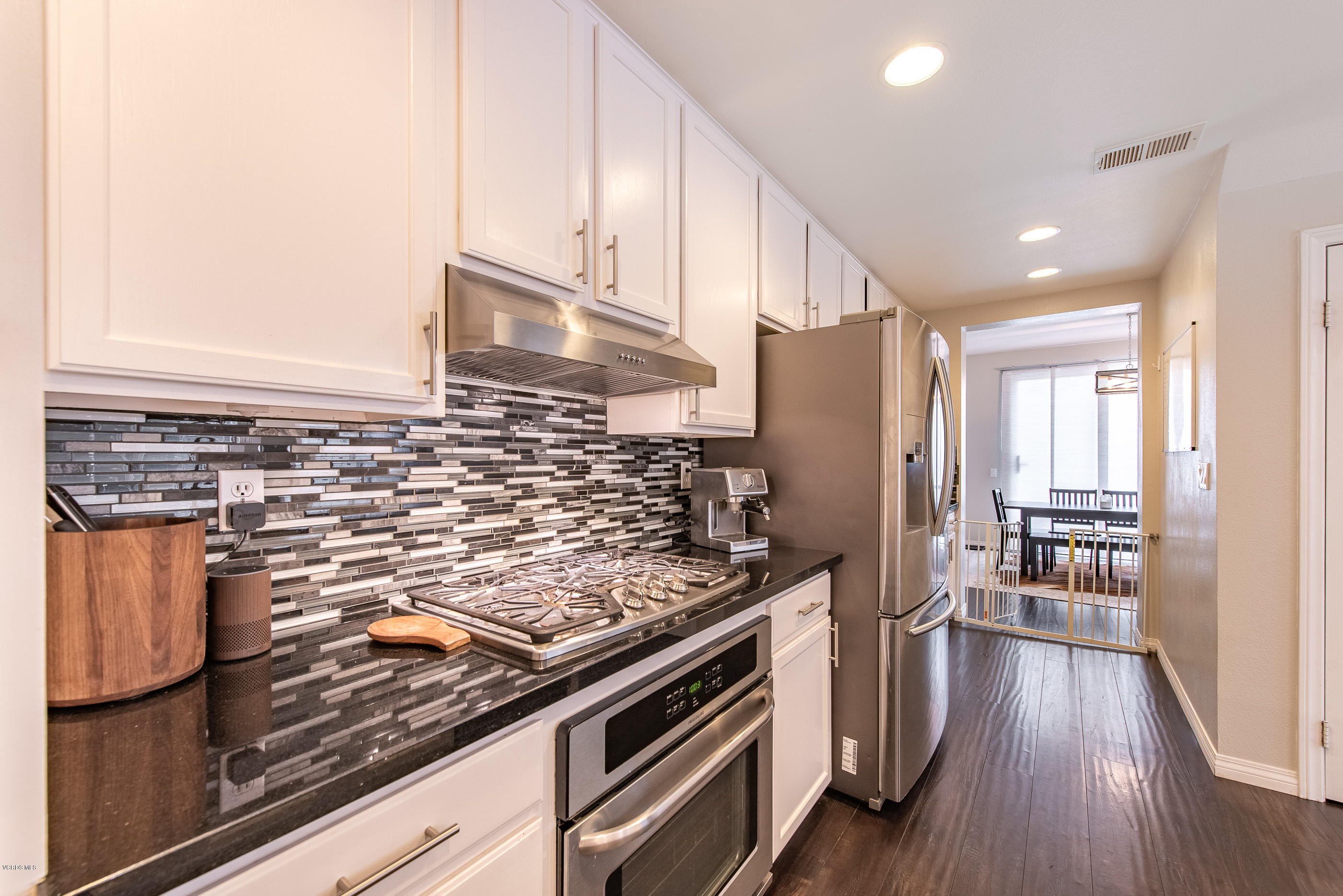 308 Hedge Row Lane, Unit B Simi Valley, CA 93065 - Photo 14 of 27 a kitchen with stainless steel appliances granite countertop a stove and a refrigerator
