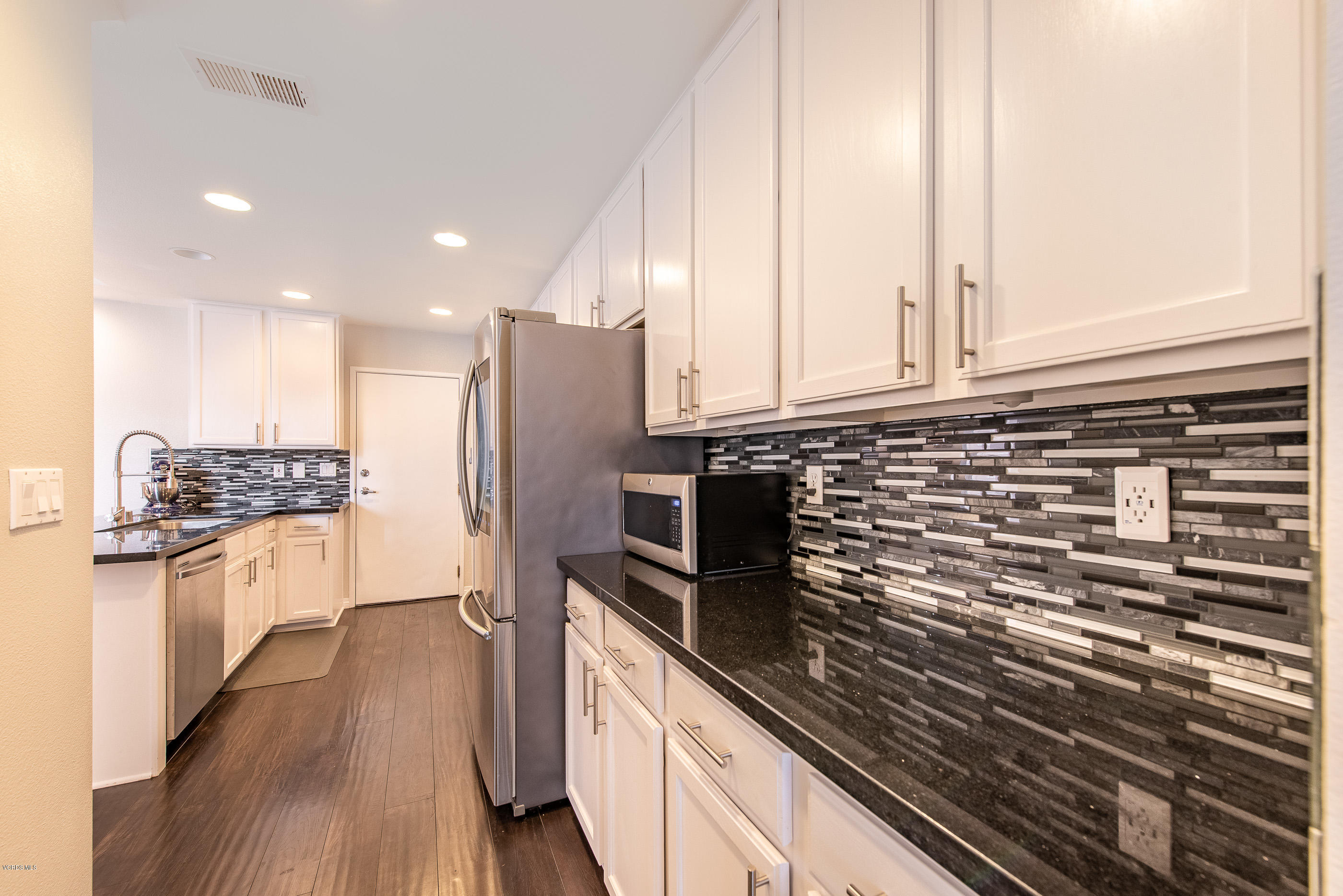 308 Hedge Row Lane, Unit B Simi Valley, CA 93065 - Photo 15 of 27 a kitchen with stainless steel appliances granite countertop a stove a sink and a refrigerator