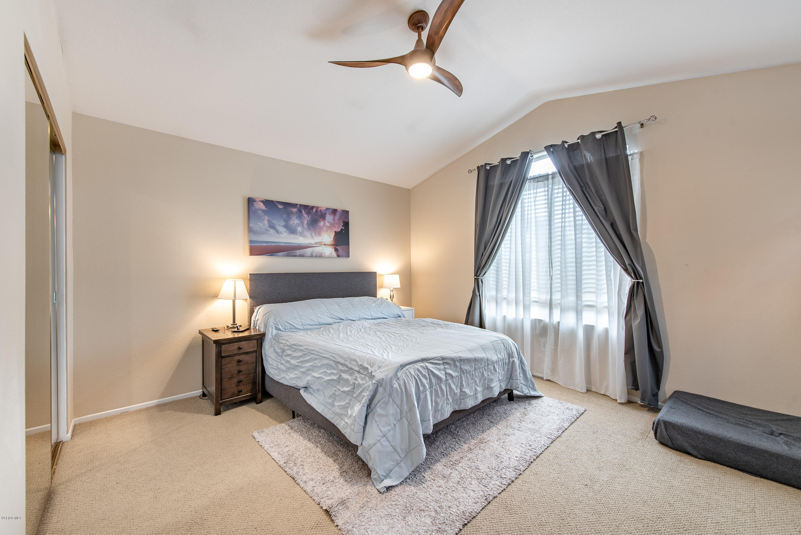 308 Hedge Row Lane, Unit B Simi Valley, CA 93065 - Photo 17 of 27 a bedroom with a large bed and a chandelier