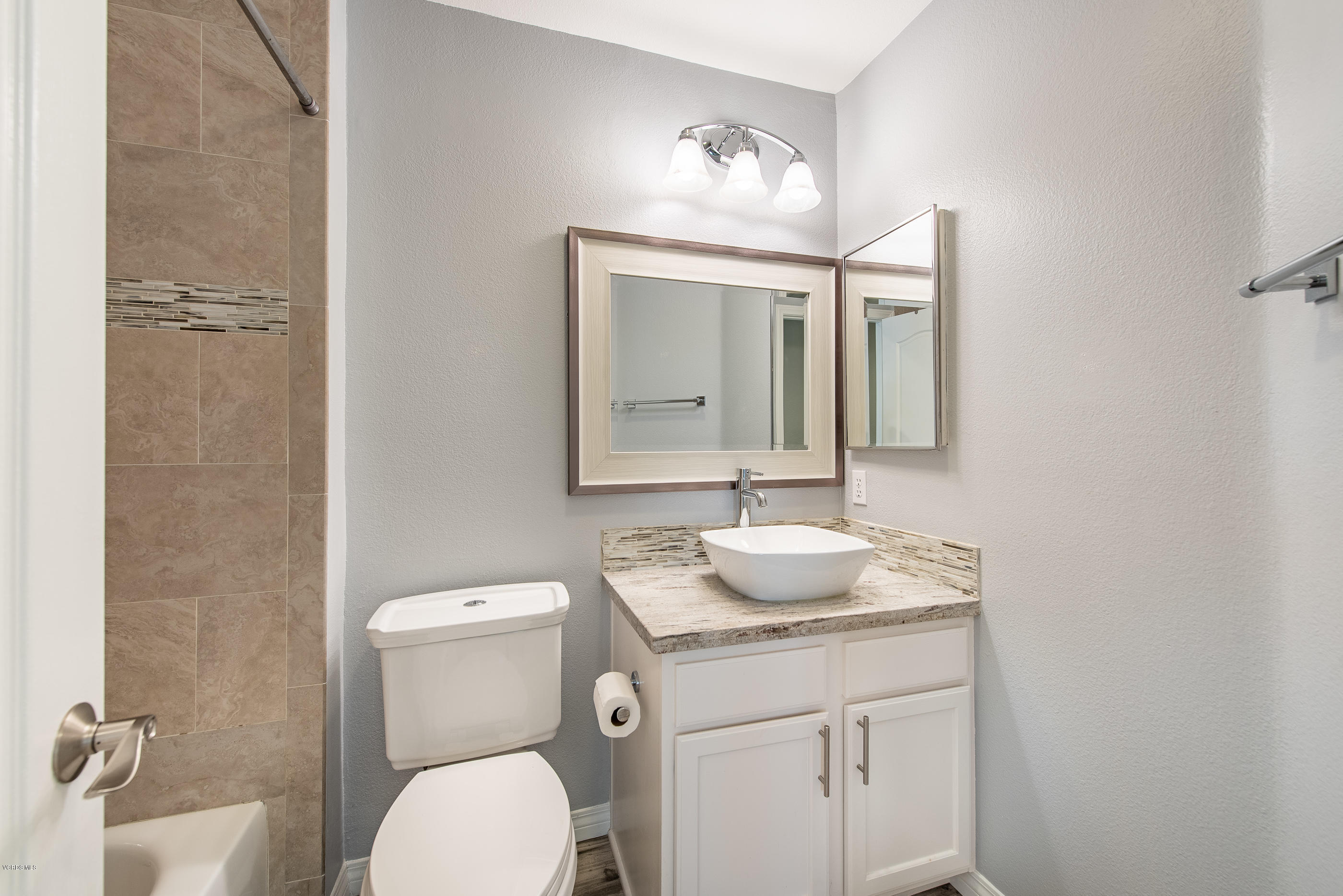 308 Hedge Row Lane, Unit B Simi Valley, CA 93065 - Photo 23 of 27 a bathroom with a toilet sink and mirror