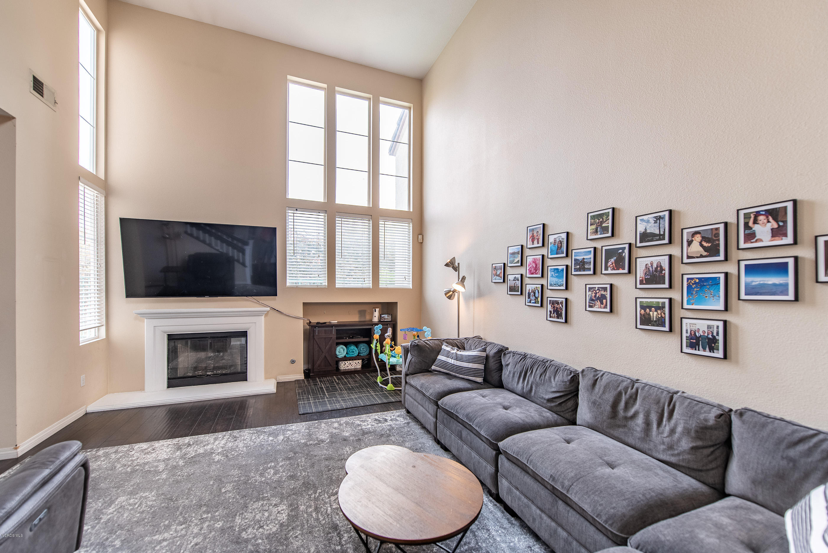 308 Hedge Row Lane, Unit B Simi Valley, CA 93065 - Photo 4 of 27 a living room with furniture a flat screen tv and a fireplace