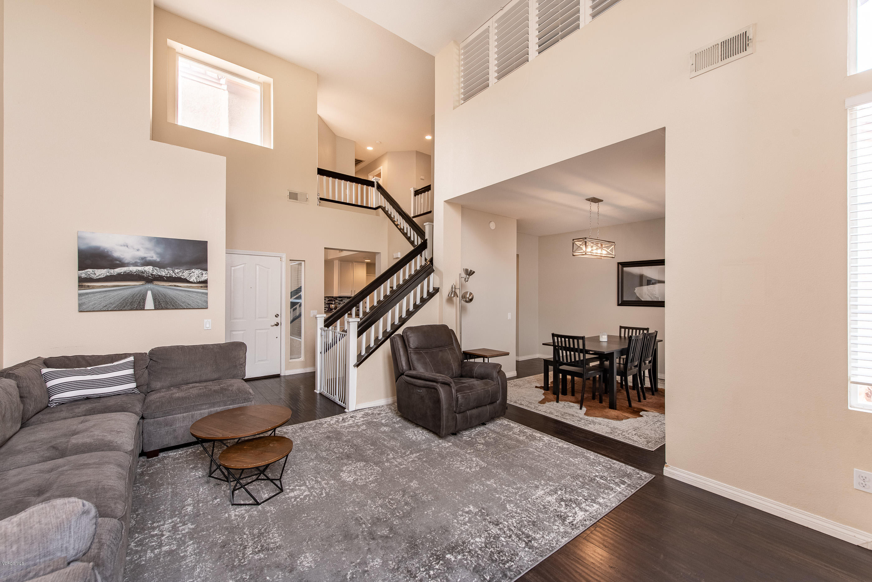 308 Hedge Row Lane, Unit B Simi Valley, CA 93065 - Photo 5 of 27 a living room with furniture and a dining table with wooden floor