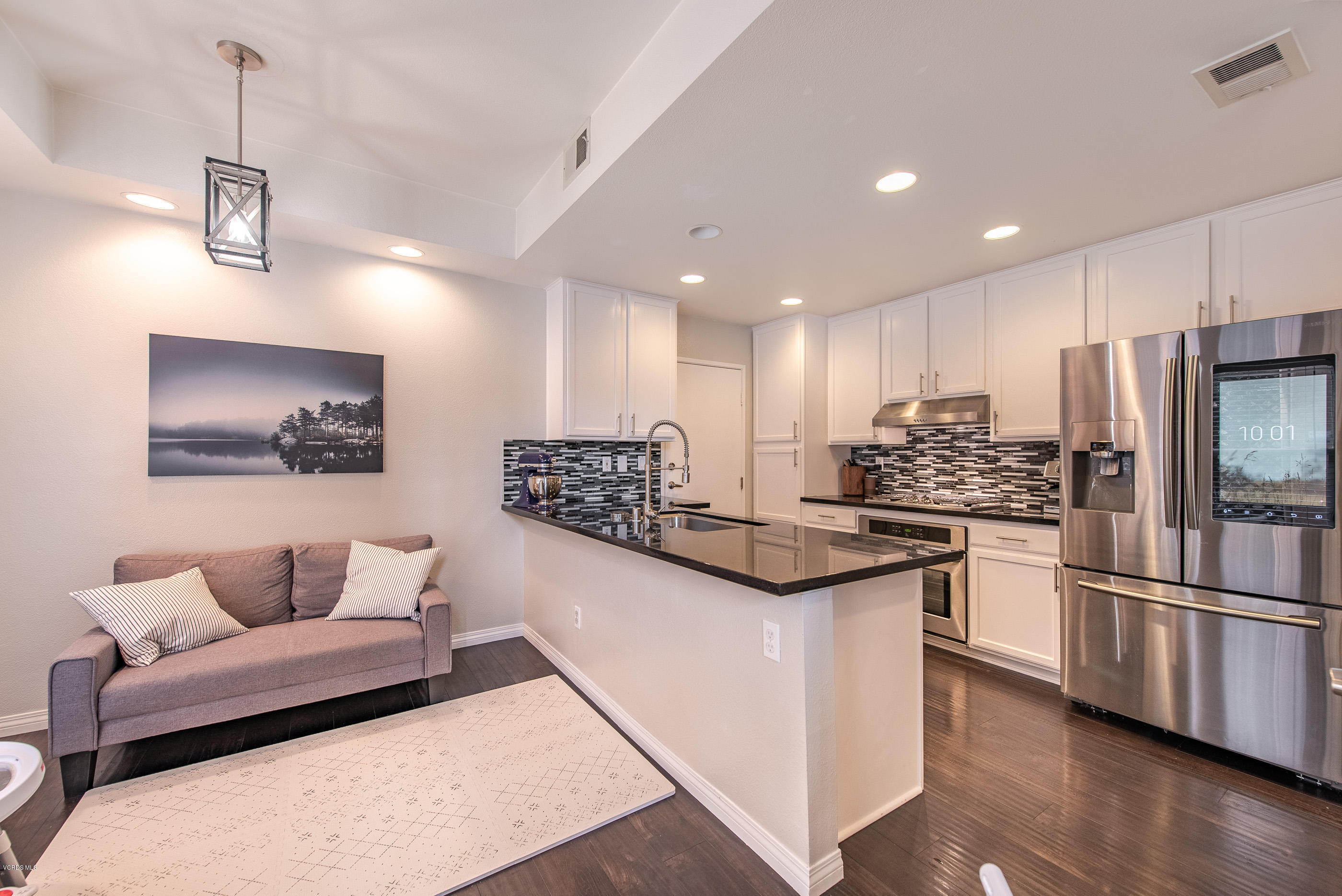308 Hedge Row Lane, Unit B Simi Valley, CA 93065 - Photo 9 of 27 a kitchen with stainless steel appliances kitchen island granite countertop a refrigerator and a stove top oven
