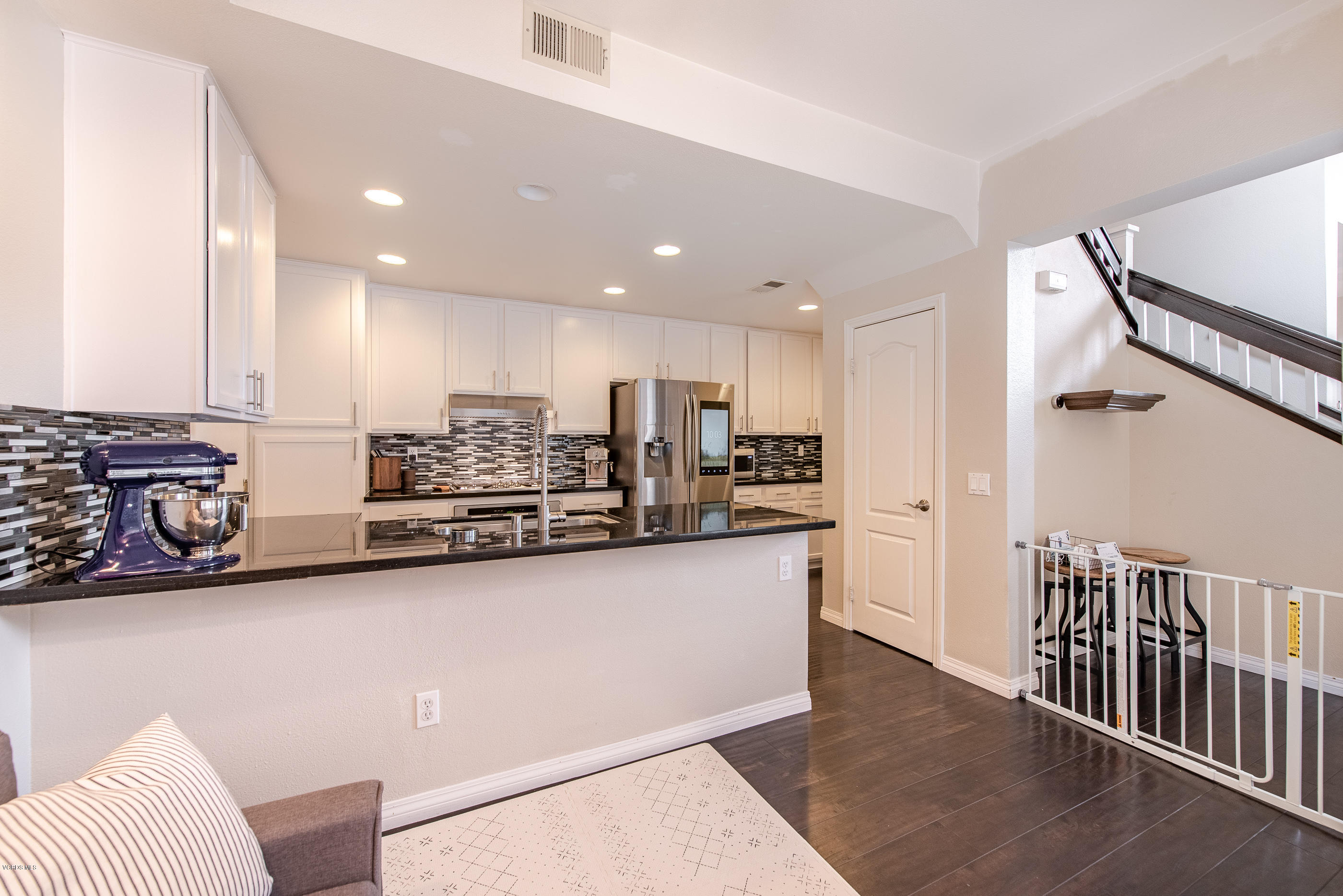 308 Hedge Row Lane, Unit B Simi Valley, CA 93065 - Photo 10 of 27 a kitchen with stainless steel appliances kitchen island granite countertop a refrigerator and a stove top oven
