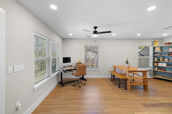 a living room with furniture and a wooden floor