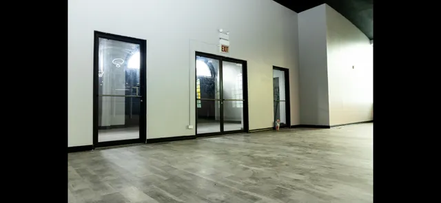 a view of an empty room with closet and mirror