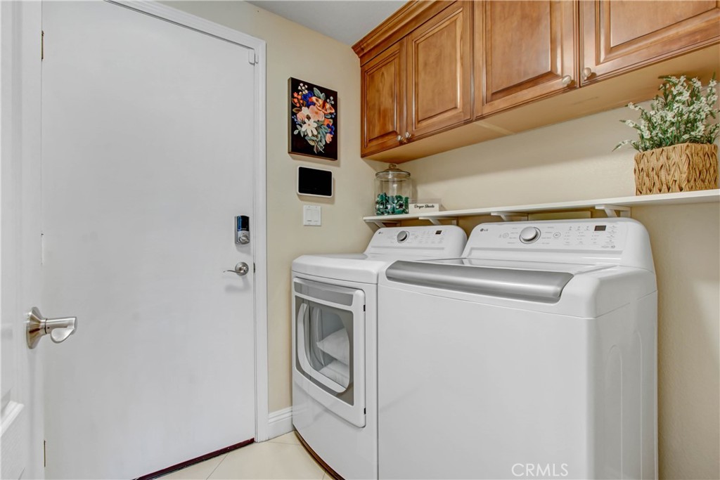 12036 Wood Ranch Road Granada Hills, CA 91344 - Photo 20 of 55 Laundry Room with sink and custom cabinetry
