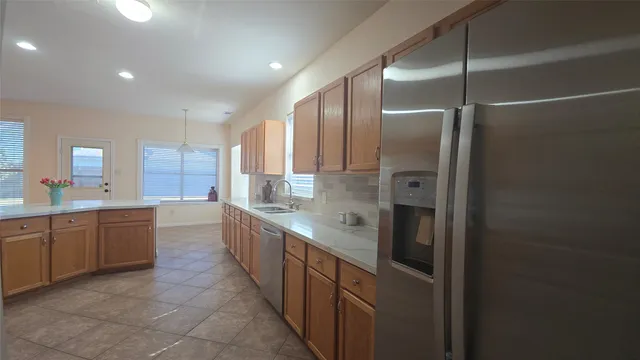 a large kitchen with a large counter top sink and cabinets