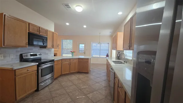 a kitchen with a sink stainless steel appliances and cabinets