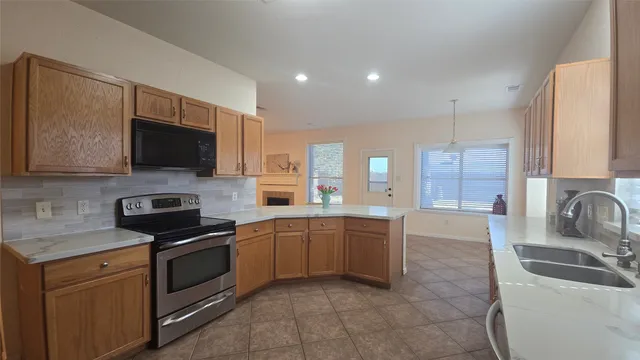 a kitchen with stainless steel appliances granite countertop a sink and a stove
