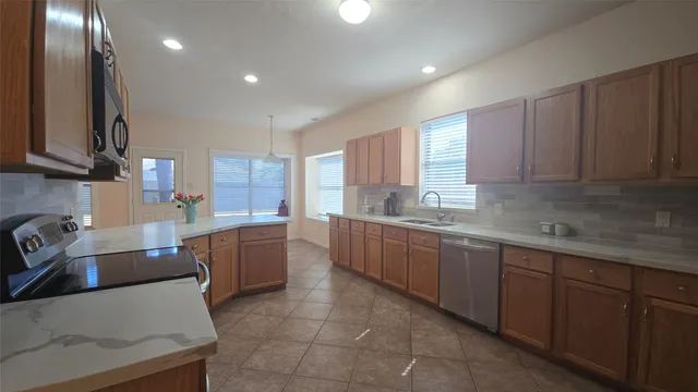 a kitchen with a sink a counter top space and cabinets