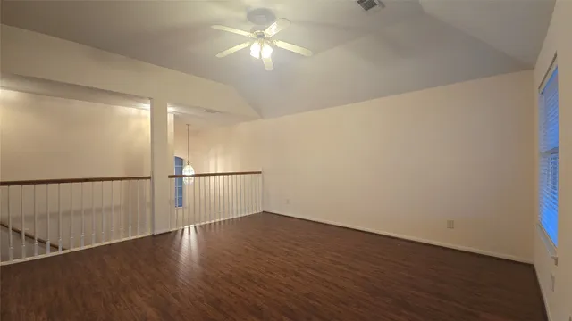a view of a room with wooden floor