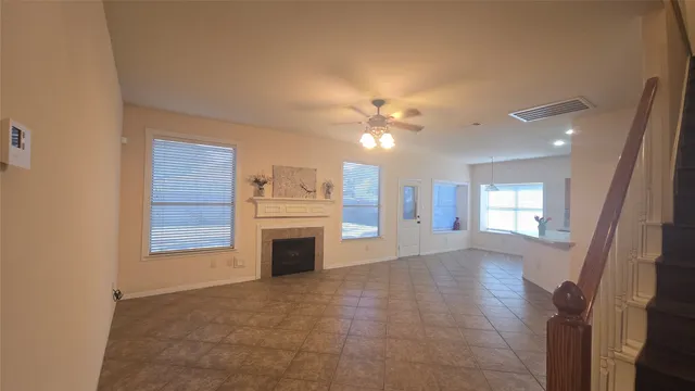 a view of a livingroom with a fireplace and window