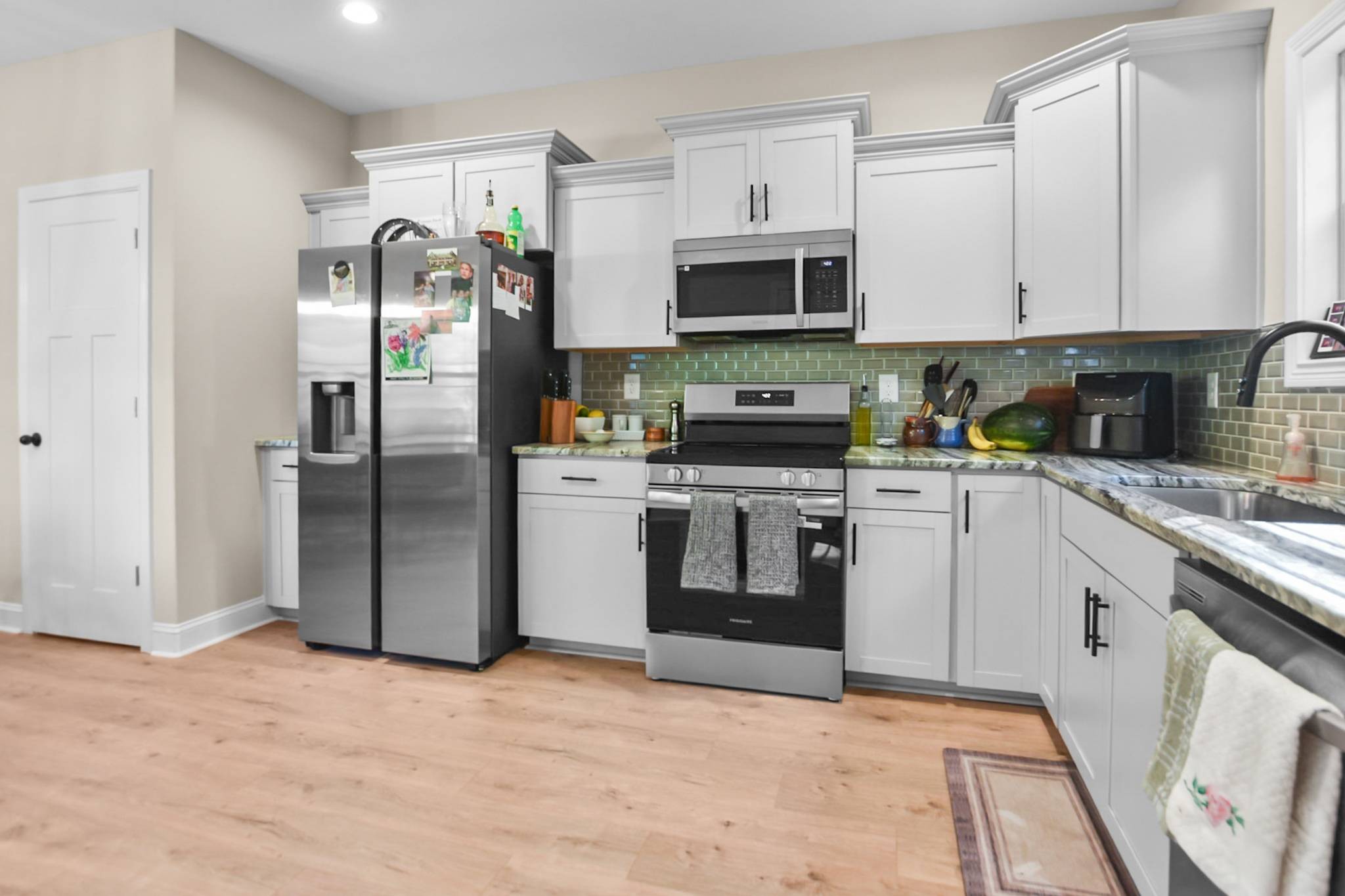 60 Cave Springs Road, Unit B Clarksville, TN 37042 - Photo 7 of 16 a kitchen with stainless steel appliances kitchen island granite countertop a refrigerator a stove top oven a sink and dishwasher