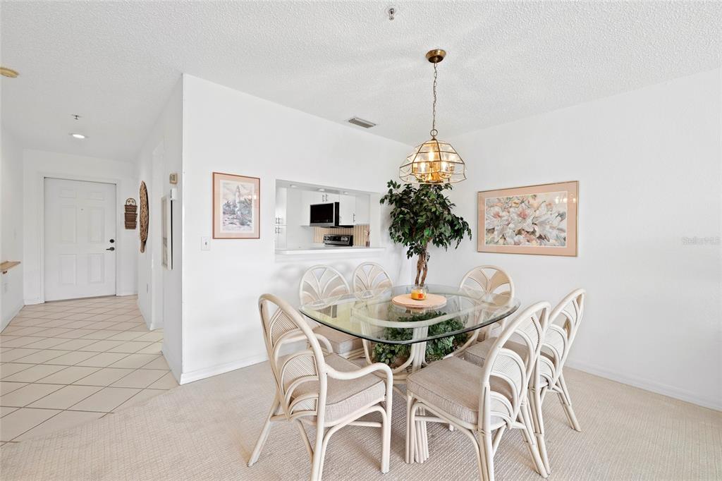 6507 Stone River Road, Unit 304 Bradenton, FL 34203 - Photo 14 of 51 a view of a dining room with furniture and wooden floor