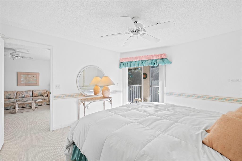 6507 Stone River Road, Unit 304 Bradenton, FL 34203 - Photo 18 of 51 a bedroom with a bed and a chandelier