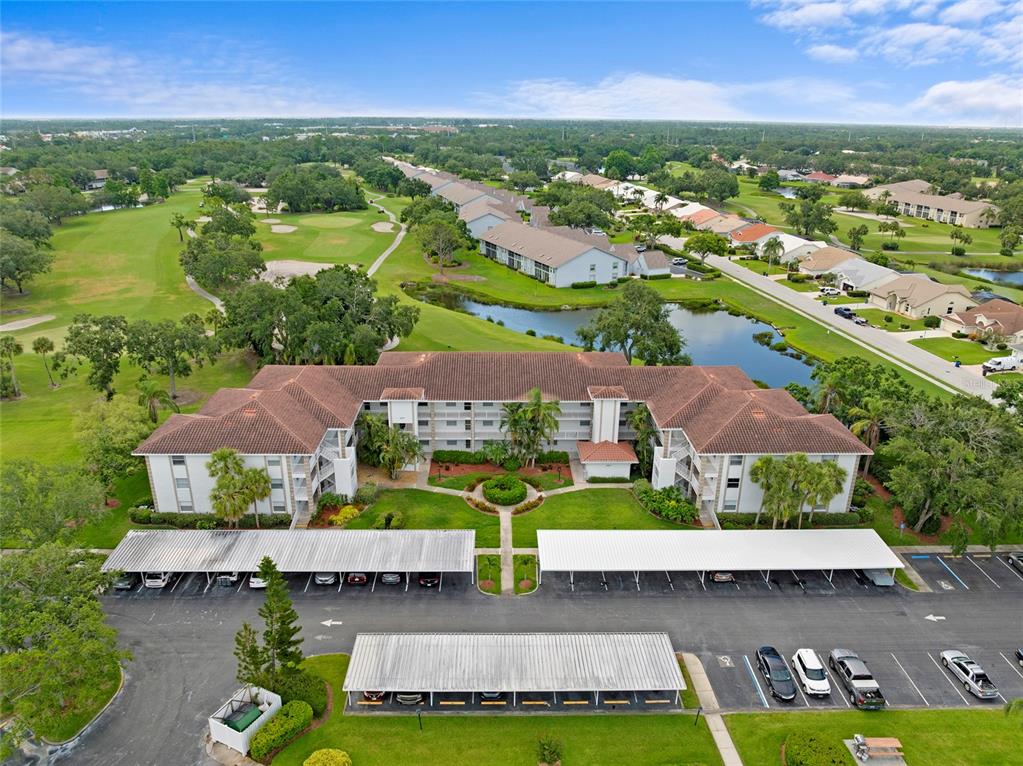 6507 Stone River Road, Unit 304 Bradenton, FL 34203 - Photo 3 of 51 an aerial view of a house with a garden and lake view