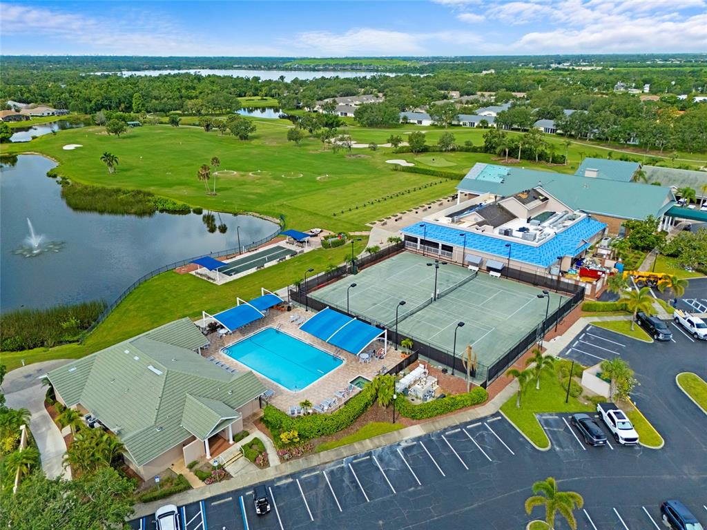 6507 Stone River Road, Unit 304 Bradenton, FL 34203 - Photo 31 of 51 an aerial view of a pool patio and outdoor seating
