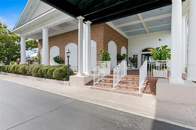 a living room with furniture a fireplace and chandelier