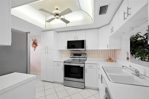 a kitchen with a table chairs and a refrigerator