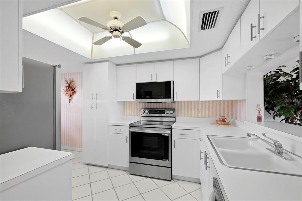 6507 Stone River Road, Unit 304 Bradenton, FL 34203 - Photo 7 of 51 a kitchen with a sink stove and microwave
