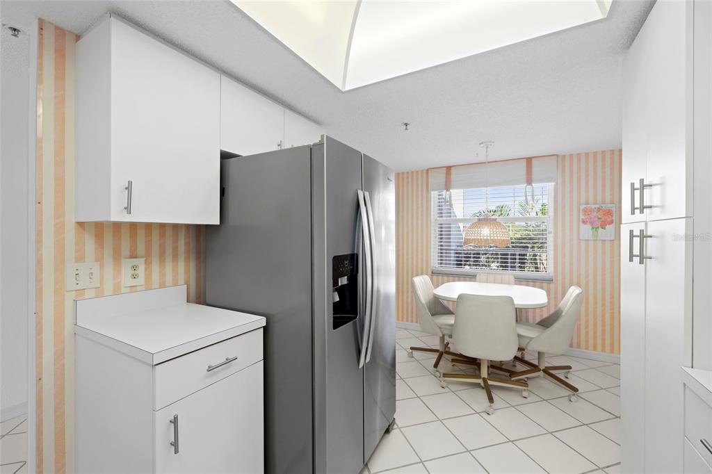 6507 Stone River Road, Unit 304 Bradenton, FL 34203 - Photo 8 of 51 a kitchen with a table chairs and a refrigerator