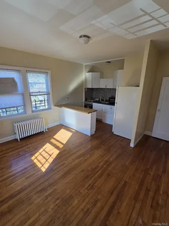 a floor to ceiling window and wooden floor