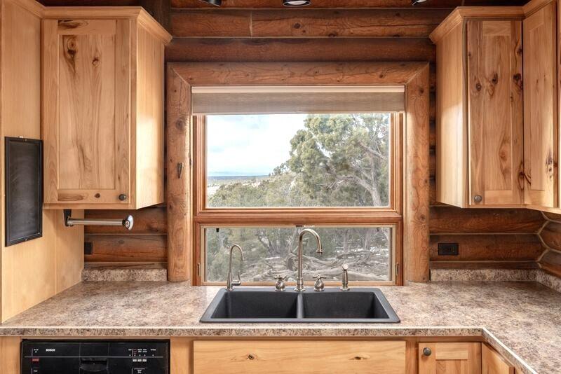 1391 North County Road Norwood, CO 81423 - Photo 13 of 34 a kitchen with a sink a counter top space and cabinets