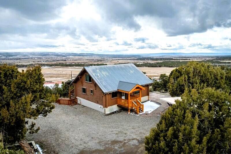1391 North County Road Norwood, CO 81423 - Photo 19 of 34 an aerial view of a house with a garden and lake view