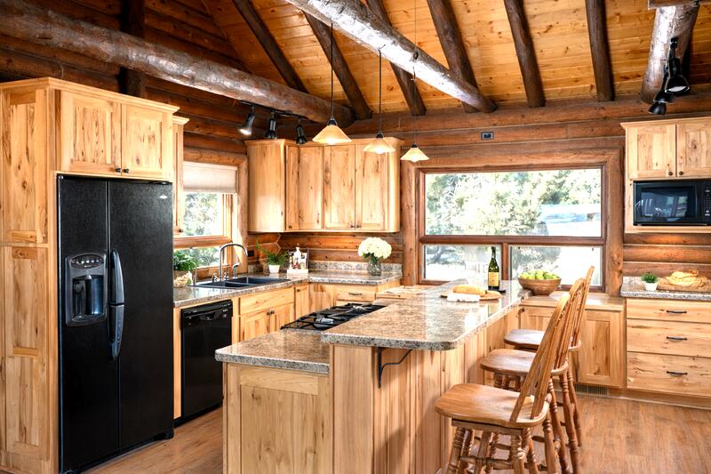 1391 North County Road Norwood, CO 81423 - Photo 27 of 34 a kitchen with stainless steel appliances kitchen island granite countertop a refrigerator a sink a stove and island