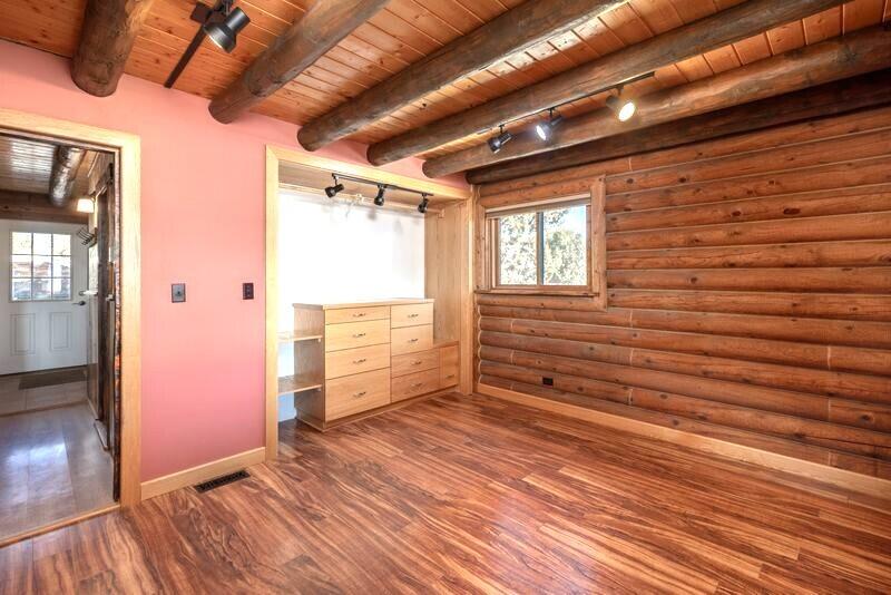 1391 North County Road Norwood, CO 81423 - Photo 5 of 34 a view of an empty room with wooden floor and a window