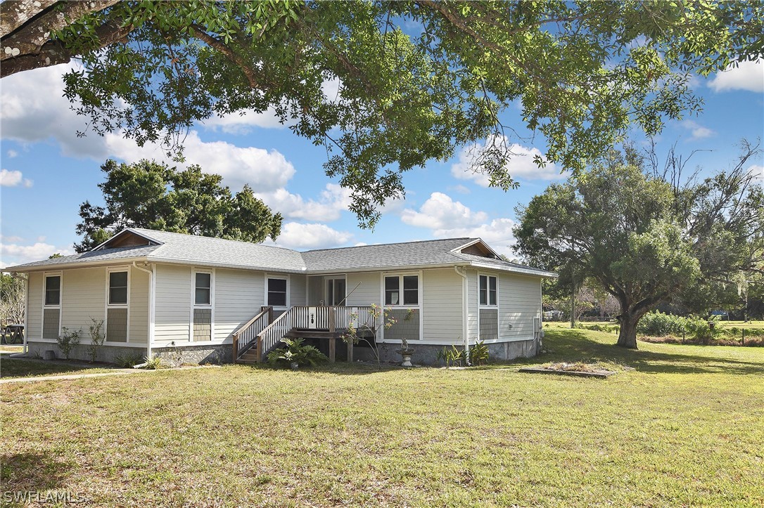 22551 Tuckahoe Road Alva, FL 33920 - Photo 2 of 30 a front view of house with yard and trees around