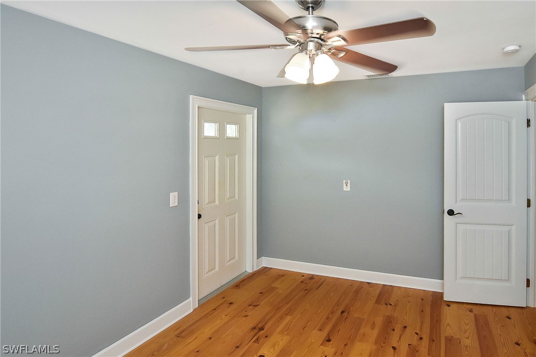 22551 Tuckahoe Road Alva, FL 33920 - Photo 23 of 30 wooden floor in an empty room