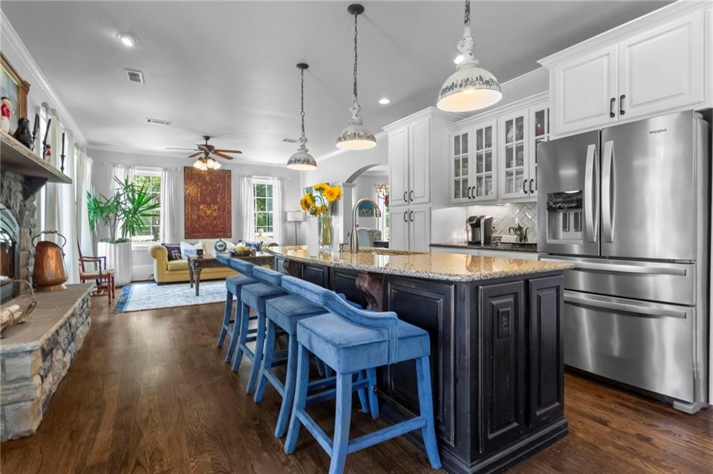 285 Old Hornage Road Ball Ground, GA 30107 - Photo 32 of 76 a kitchen with stainless steel appliances a table chairs and a chandelier