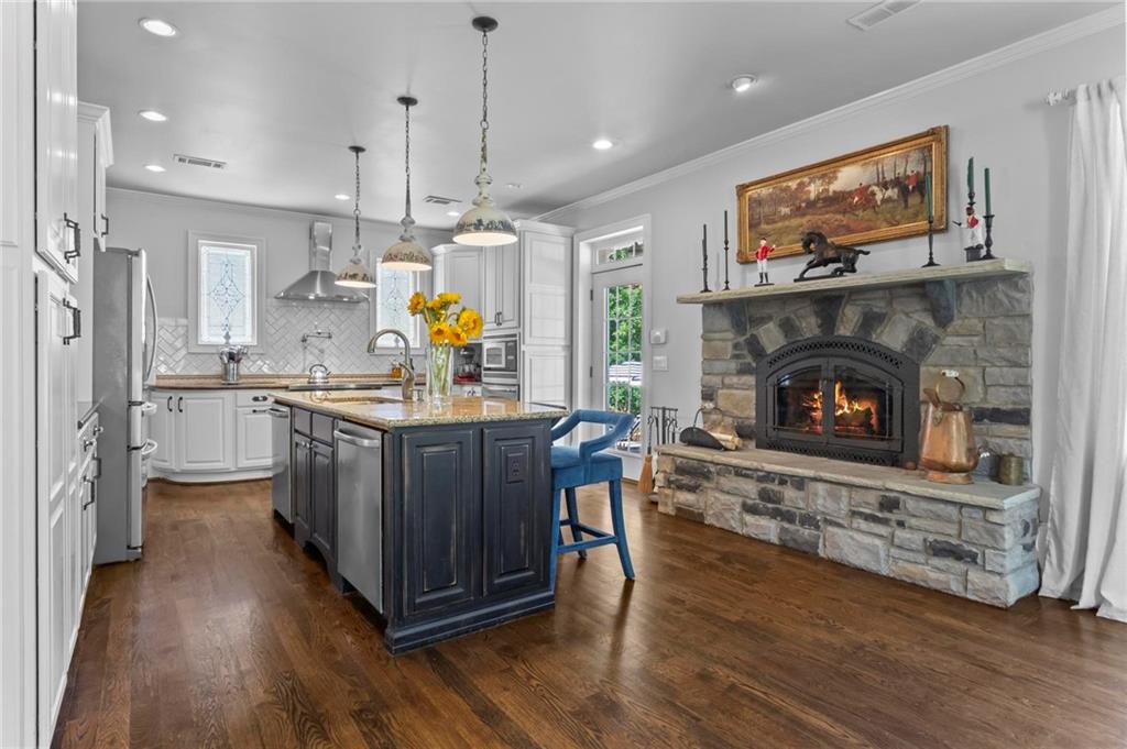 285 Old Hornage Road Ball Ground, GA 30107 - Photo 33 of 76 a kitchen with wooden floors and appliances