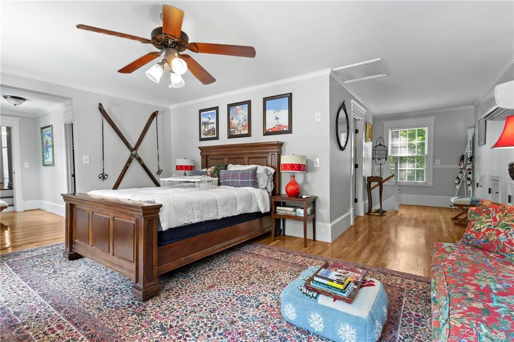 285 Old Hornage Road Ball Ground, GA 30107 - Photo 48 of 76 a bedroom with bed and a chandelier