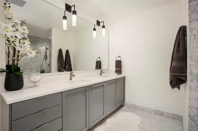 a bathroom with a double vanity sink and a mirror