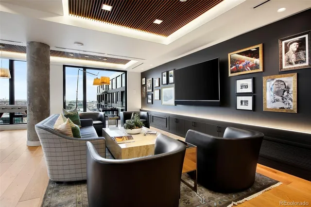 a living room with couches and a flat screen tv