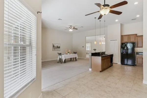 a view of a livingroom with furniture and a ceiling fan