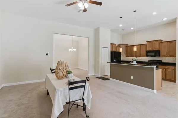 a kitchen with kitchen island a white counter top space appliances and cabinets