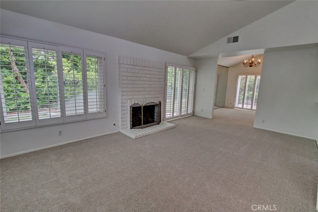 8 Sparrowhawk Irvine, CA 92604 - Photo 14 of 59 a view of an empty room with a fireplace and a window