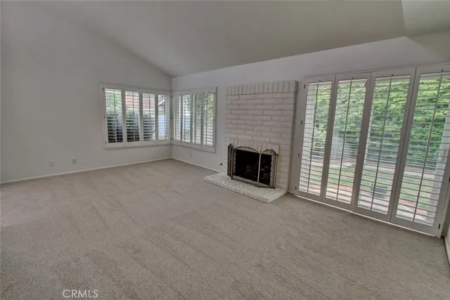 an empty room with furniture and fireplace