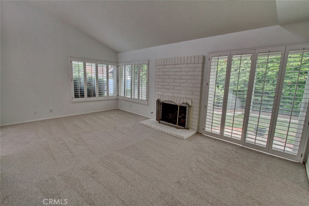 8 Sparrowhawk Irvine, CA 92604 - Photo 15 of 59 an empty room with furniture and fireplace
