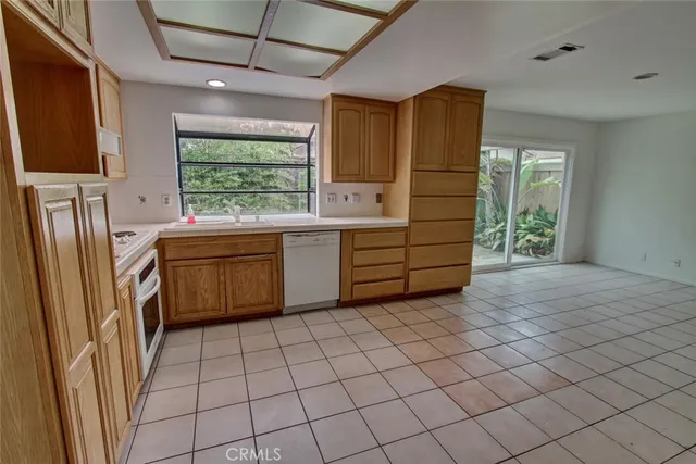 a kitchen with stainless steel appliances granite countertop a sink and a refrigerator
