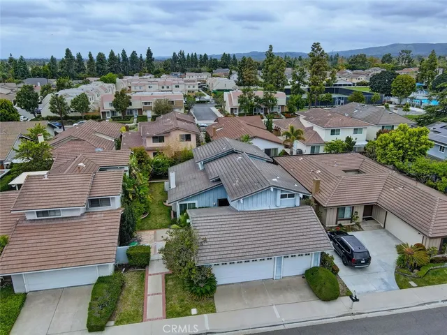 an aerial view of multiple houses with a yard
