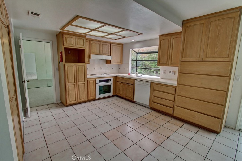 8 Sparrowhawk Irvine, CA 92604 - Photo 21 of 59 a kitchen with stainless steel appliances granite countertop a sink and a refrigerator
