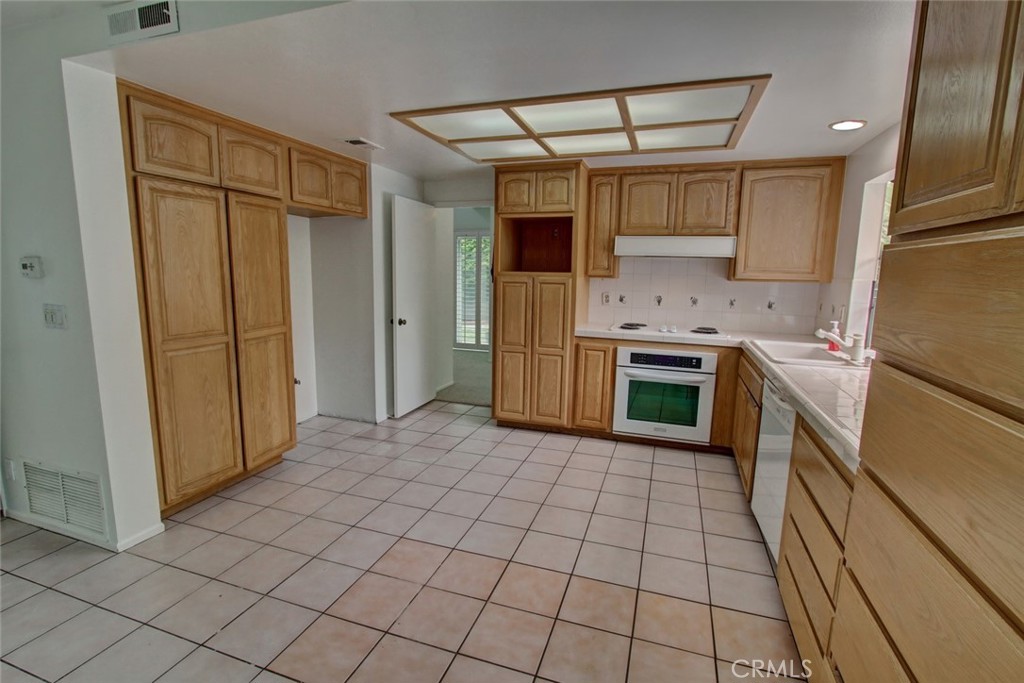 8 Sparrowhawk Irvine, CA 92604 - Photo 22 of 59 a kitchen with stainless steel appliances granite countertop a refrigerator and a stove top oven