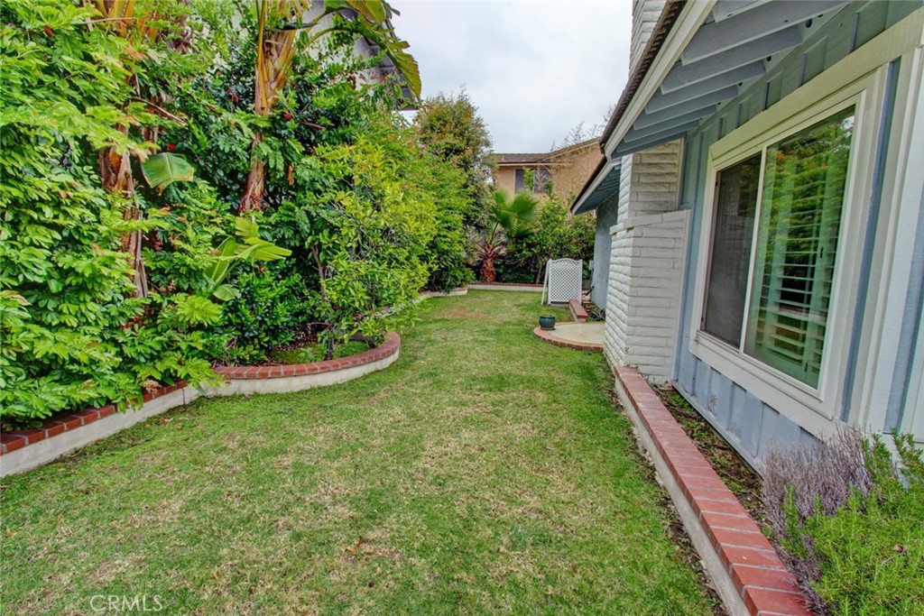 8 Sparrowhawk Irvine, CA 92604 - Photo 33 of 59 a view of a backyard with potted plants and floor to ceiling window