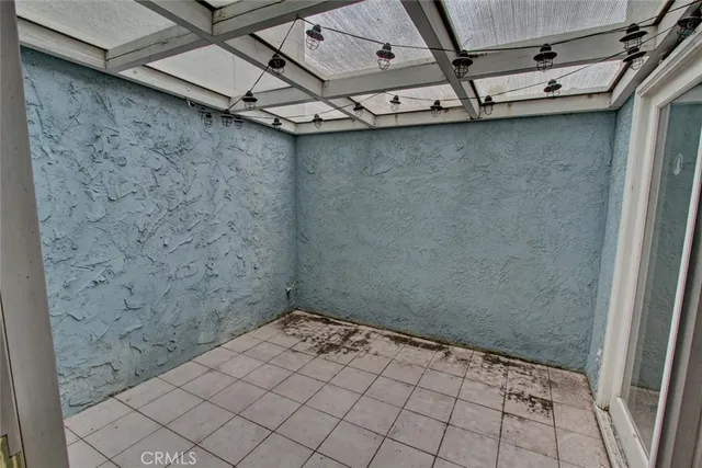 a view of an empty room with glass door